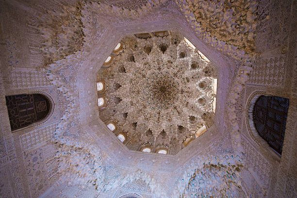 Intricate Nasrid Side Chamber in Alhambra Featuring Arabic Calligraphy, Geometric Stucco, and Ornate Wooden Ceiling in the Royal Palace of Granada, Spain