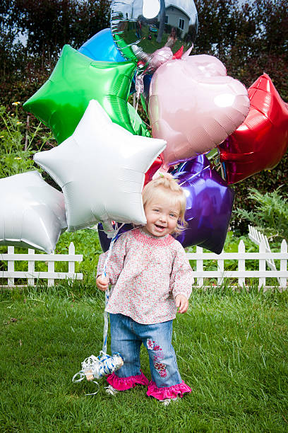 istock Little Girl with Balloons 471468657