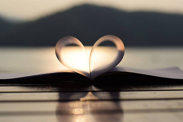 istock close up heart shape from paper book at sunset 471470698