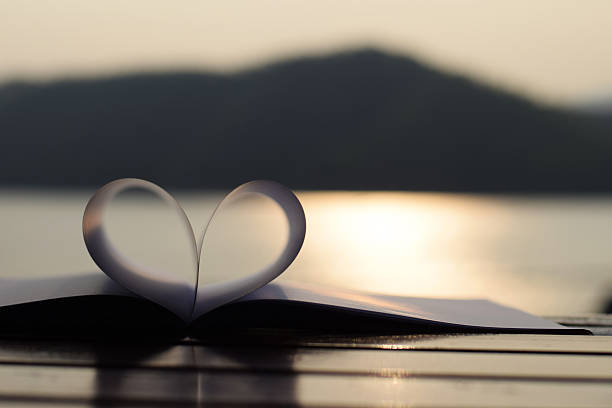 istock close up heart shape from paper book at sunset 471470700