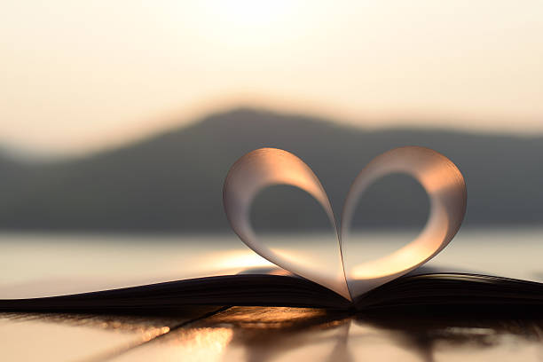 istock close up heart shape from paper book at sunset 471470702