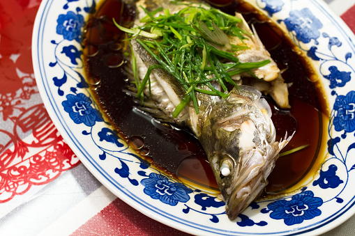 A dish of steamed fish cooked in Chinese style.