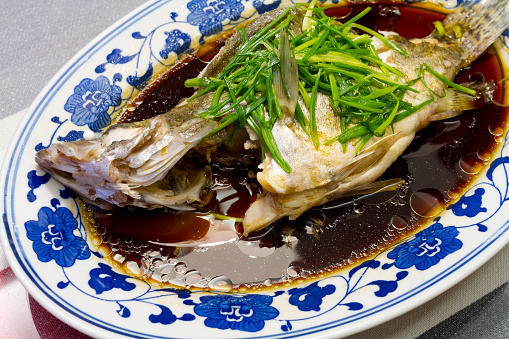 A dish of steamed fish cooked in Chinese style.