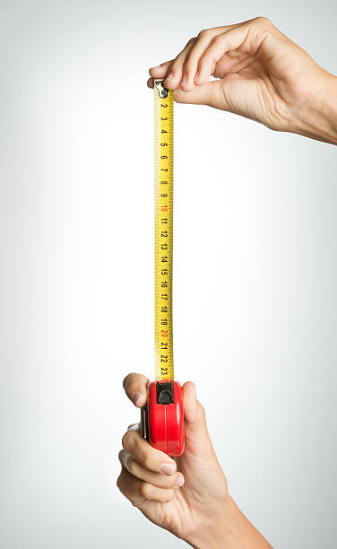 Taking a Measurement (XXXL) Natural groomed Hands taking a Measurement. Nikon D800e. Converted from RAW. human height stock pictures, royalty-free photos & images