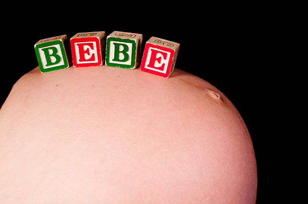 pregnancy belly with the word "bébé" on it stock photo