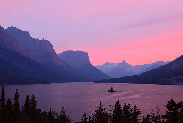 St. Mary's Lake, with Wild Goose Island in the middle, sits amid the mountains of Glacier National Park after sunset. Smoke from wildfires in the region provides for beautiful color.