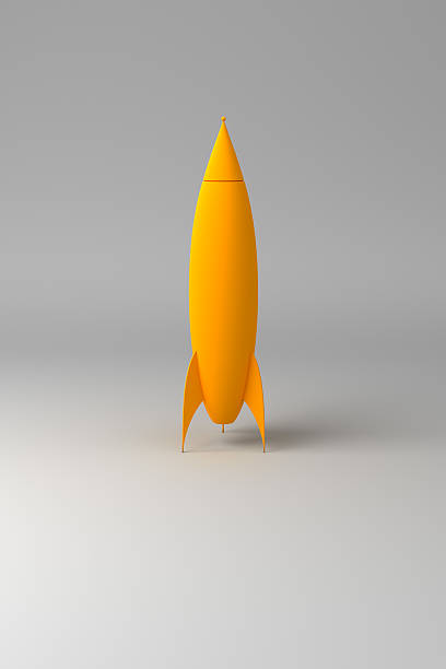 Yellow Rocket Yellow rocket on gray background model rocket stock pictures, royalty-free photos & images