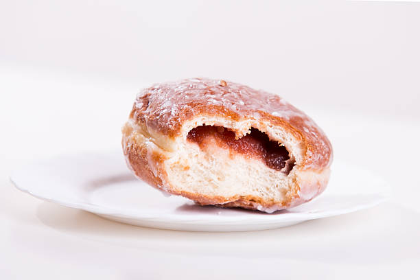 istock Bitten donut with jam lies on a plate 471474602