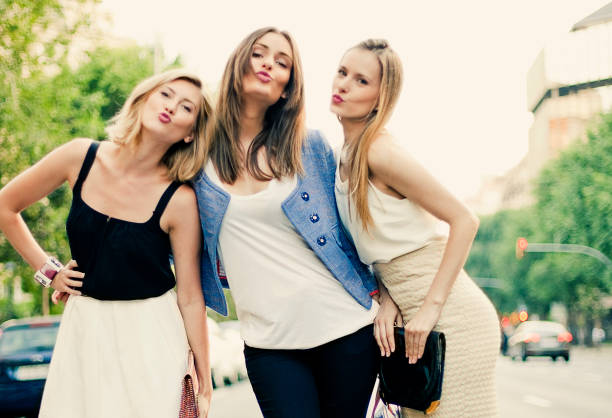 Friends Friends in the street in Barcelona three way kiss stock pictures, royalty-free photos & images