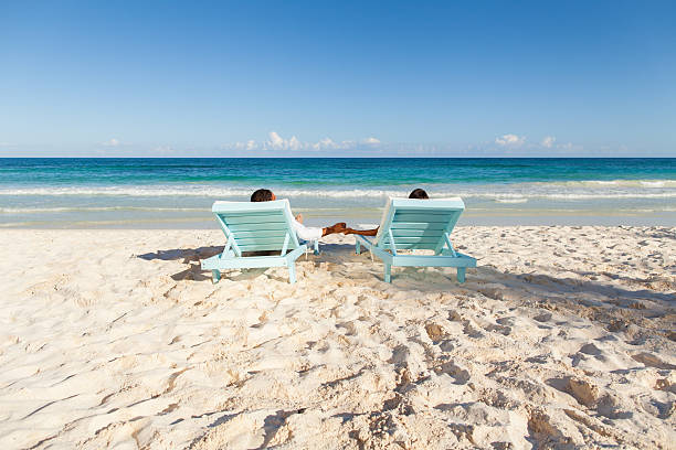 istock Couple relaxing on the beach 471475189