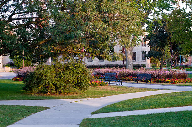 istock park benches row bricks sidewalk path grass trees  buildings fences 471475513