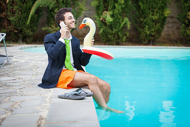 istock Funny Young Businessman with SwimmingTrunks next to the Pool 471475683