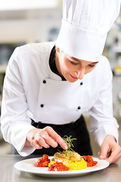 istock Female Chef in restaurant kitchen cooking 471475799