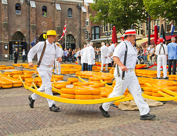 Alkmaar, The Netherlands - September 7 2012: Carriers walking with cheese at a famous Dutch cheese market.