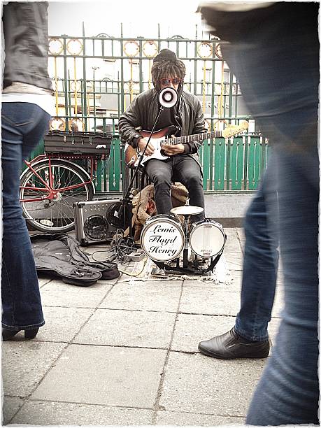 London, UK - 4 October 2012: A 'one man band' busker on the streets of London entertaining passing shoppers in the centre of one of the major shopping areas.  