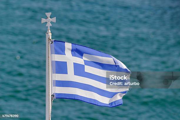 Greek Flag Aginst Turquoise Ocean Stock Photo - Download Image Now - 2015, Blue, Classical Greek