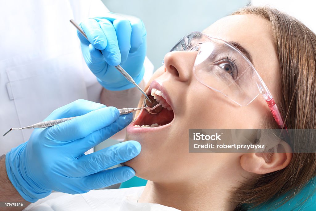 Overview of dental caries prevention Woman at the dentist's chair during a dental procedure Root Canal Stock Photo