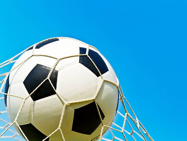 istock Soccer ball in net 471478993
