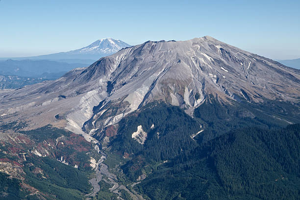 Summit of Mt St Helens located in Washington State. Picture taken from an airplane near the peaks altitude. Shows Washington State mountains, Mt Saint Helens and Mt Rainier in the background.  This is viewed from the South West. Both mountains have a small amount of snow. Taken in October after an unusually dry period.