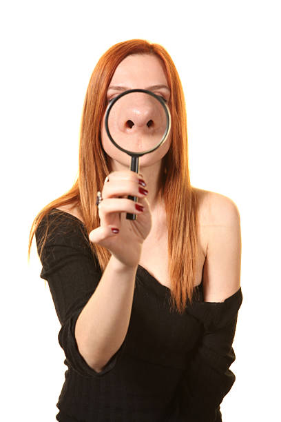 istock Red haired woman with magnifier 471480965