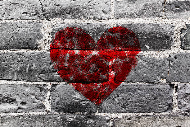 istock Painted Red Heart Shape on Black Brick Wall 471482208