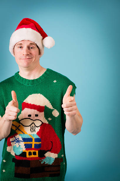 istock Man Thinks He's Cool Wearing Santa Hat and Ugly Vest 471482673
