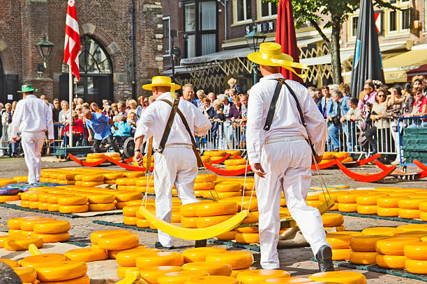 Carriers walking in the famous Dutch cheese market Alkmaar, The Netherlands - September 7 2012: Carriers walking with cheese at a famous Dutch cheese market. cheese dutch culture cheese making people stock pictures, royalty-free photos & images