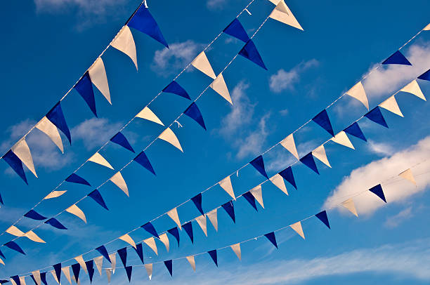Festive blue and white garlands, summer sky background