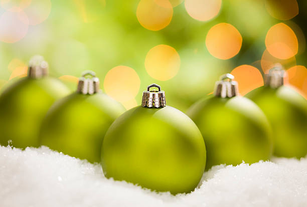 istock Green Christmas Ornaments on Snow Over an Abstract Background 471486775