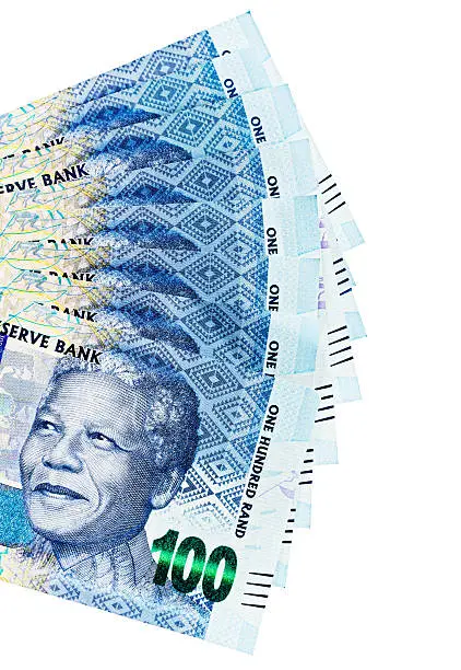 A fanned-out sheaf of new One Hundred Rand notes, part of the new South African range of "Mandela" banknotes, create a striking ethnic patterns in shades of blue. Isolated on white. 