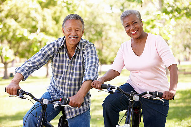 istock Senior  couple cycling in park 471488245