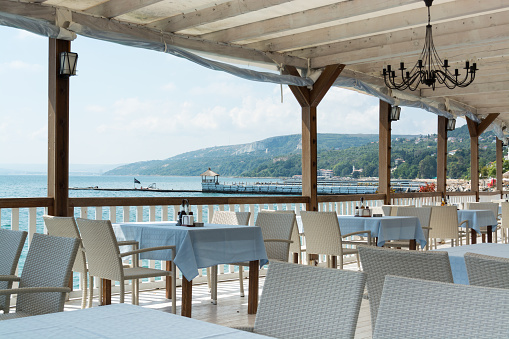 White restaurant tables and chairs, Black sea coast, Balchik, Bulgaria
