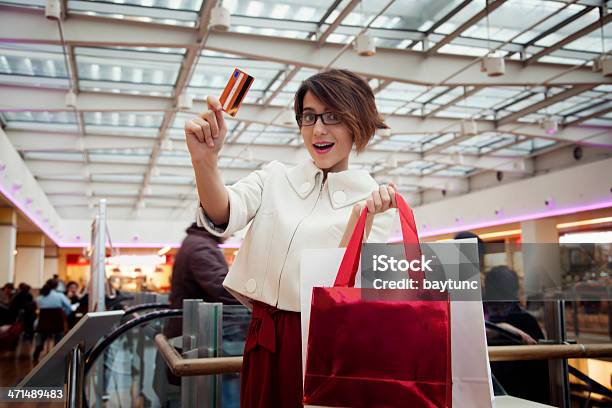 Young Woman Holding Credit Card And Carrying Shopping Bags Stock Photo - Download Image Now