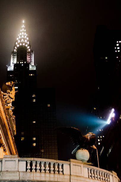 Chrysler Building New York City By Night New York, USA - December 2, 2012: The Chrysler Building and it surroundings by night. This is one of the most recognizable Manhattan skyscraper and a great example of the early 20th Century Art Deco Style. On the left part of tne Grand Central Station building and its eagle statue. chrysler building eagles stock pictures, royalty-free photos & images