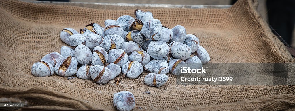 coal roasted chestnuts Fresh roasted chestnuts from a street vendor in lisbon portugal 2015 Stock Photo