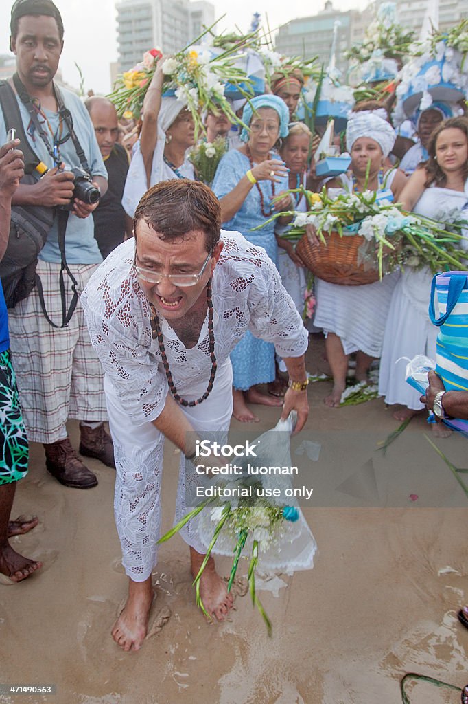 Iemanja´s honour party in Rio de Janeiro Rio de Janeiro, Brazil – December 29th, 2012: Babalorixa throws flowers in Copacabana Beach sea during Iemanja´s honour party at  the end of the year commemorations. Iemanjá Stock Photo