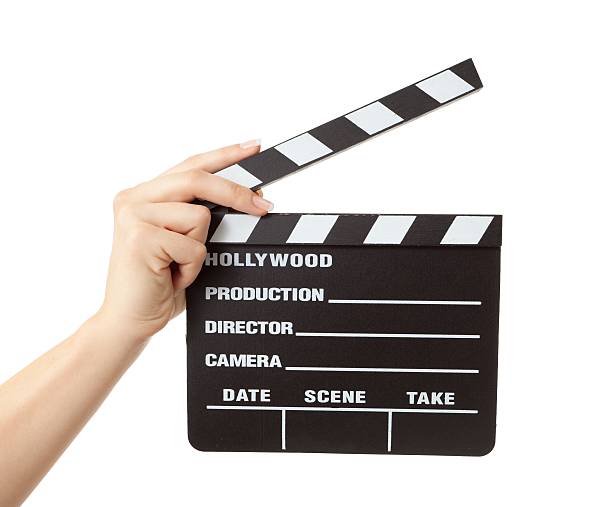 istock woman hand holding hollywood slate board isolated 471490637