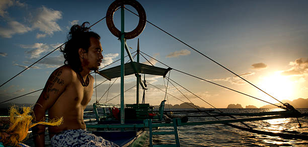 philippino con su tradicional de banca remar embarcaciones en filipinas - outrigger philippines mindanao palawan fotografías e imágenes de stock
