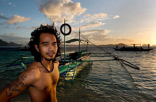 philippino con su tradicional de banca remar embarcaciones en filipinas - outrigger philippines mindanao palawan fotografías e imágenes de stock