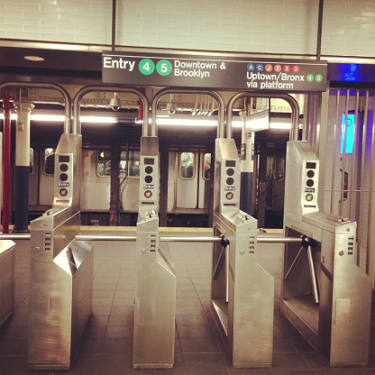 New York, New York, USA - January 4, 2013: Photo of New York City subway turnstile to access the train. This is a Fulton Street station located in Downtown Manhattan. Picture taken with mobile phone.