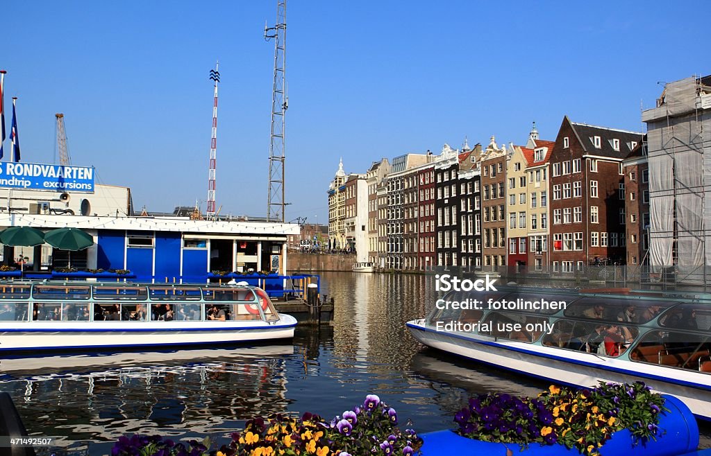 Tourist boats in Amsterdam Amsterdam, The Netherlands - April 18, 2011: Tourist boats in Amsterdam. Tourist boats with tourists start through the canals of Amsterdam on a sunny day in spring. Amsterdam Stock Photo