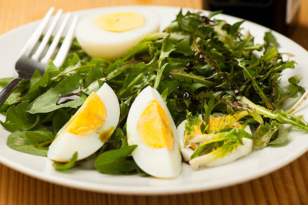 istock Fresh spring green dandelion salad with eggs on a plate 471492834