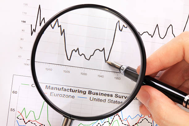 istock Hand holding magnifying glass over diagram. 471492963