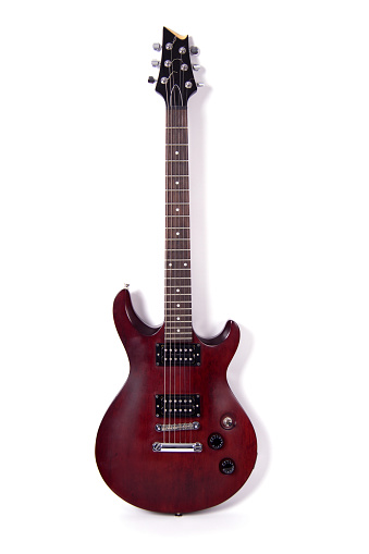 Electric guitar mahogany, Isolated on white, vertical composition, a stringed musical instrument, electronic control bodies, six-string guitar, tuning and adjustment.