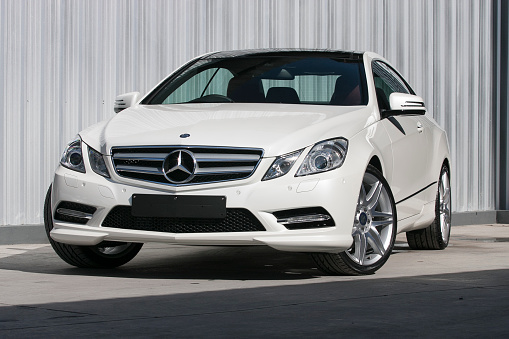 ChiangMai,Thailand - August 23, 2012: A photo of a parked White 2012 MERCEDES-BENZ E-CLASS E200 COUPE on display outside of a car dealership in Thailand,The E-Class coupe replaced the CLK, offering more space, refinement and presence.