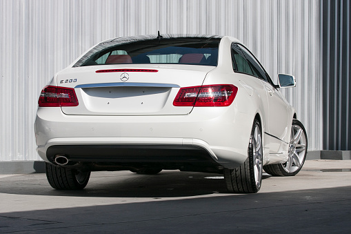 ChiangMai,Thailand - August 23, 2012: A photo of a parked White 2012 MERCEDES-BENZ E-CLASS E200 COUPE on display outside of a car dealership in Thailand,The E-Class coupe replaced the CLK, offering more space, refinement and presence.