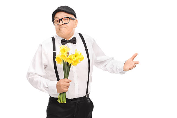 istock Confused senior gentleman holding flowers 471493492