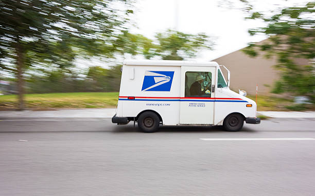 USPS truck speeding Miami, USA - January 18, 2013: United States Post Office mail truck (USPS) speeding in Miami, Florida - motion blur panning. united states postal service photos stock pictures, royalty-free photos & images