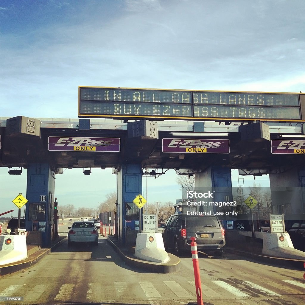 E-ZPass on Throgs Neck Bridge in New York New York, New York, USA - January 20, 2013: Passing through an EZPass  on the Throgs Neck Bridge in New York. Showing EZPass gates and traffic on the bridge. Picture taken with mobile phone.  Leaving Stock Photo