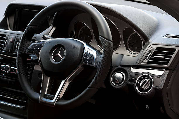 Mercedes Benz E200 interior ChiangMai,Thailand - August 23, 2012: A photo of MERCEDES-BENZ E-CLASS E200 COUPE interior.Car parked on display outside of a car dealership in Thailand,The E-Class coupe replaced the CLK, offering more space, refinement and presence. mercedes benz photos stock pictures, royalty-free photos & images